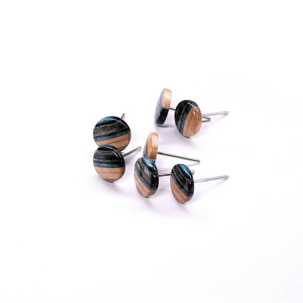 Black and blue round earrings made from recycled skateboard decks